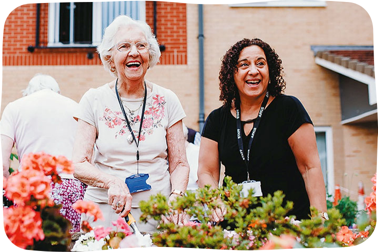 Ladies smiling at care home garden
