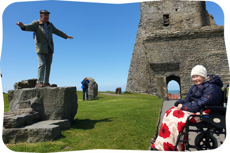 Man balancing, lady in wheelchair, Wales