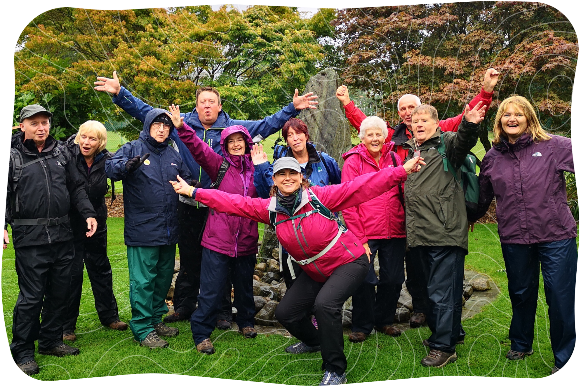 Group photo of people in raincoats.