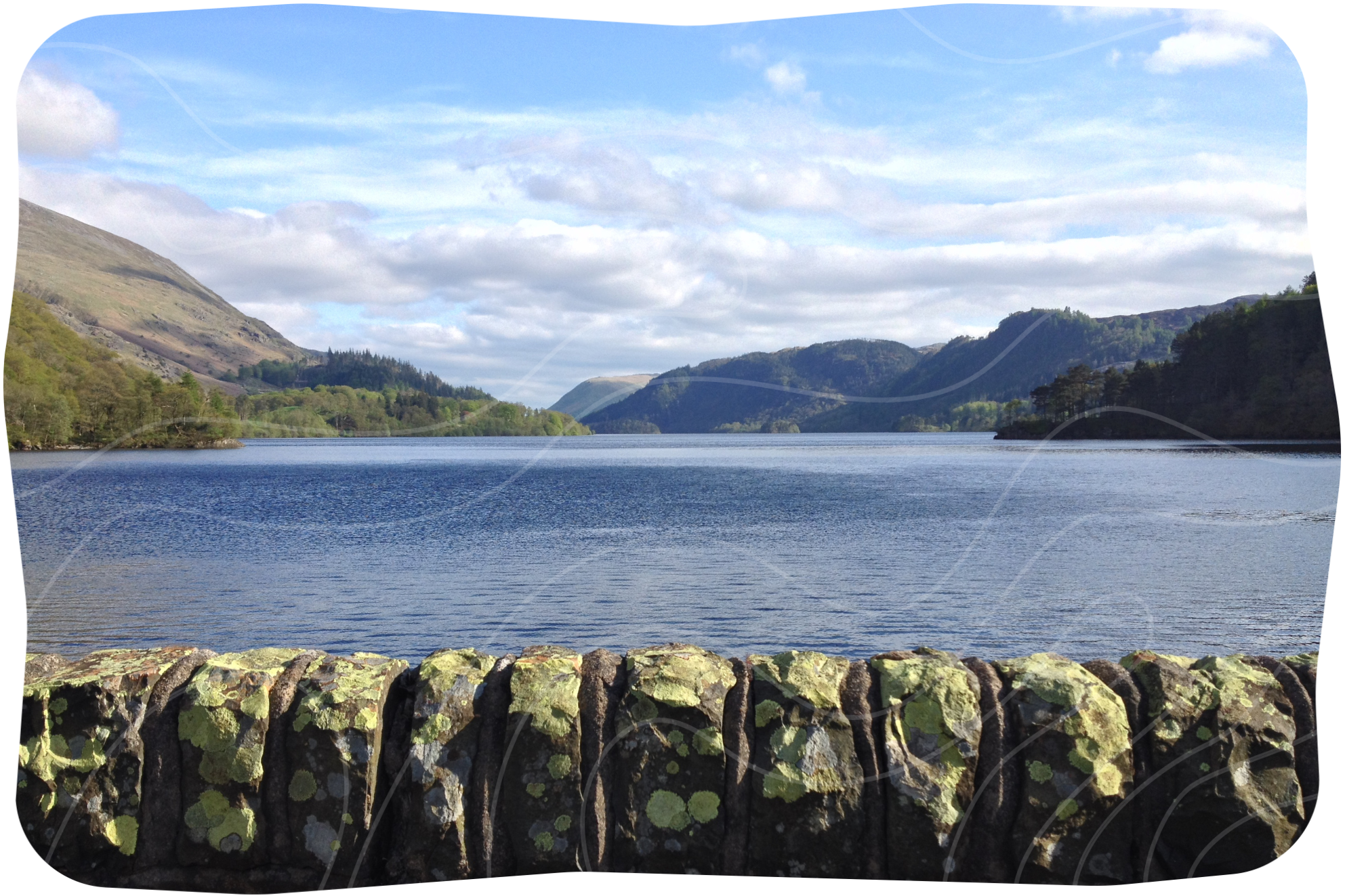 A view of a lake with mountains in the background.