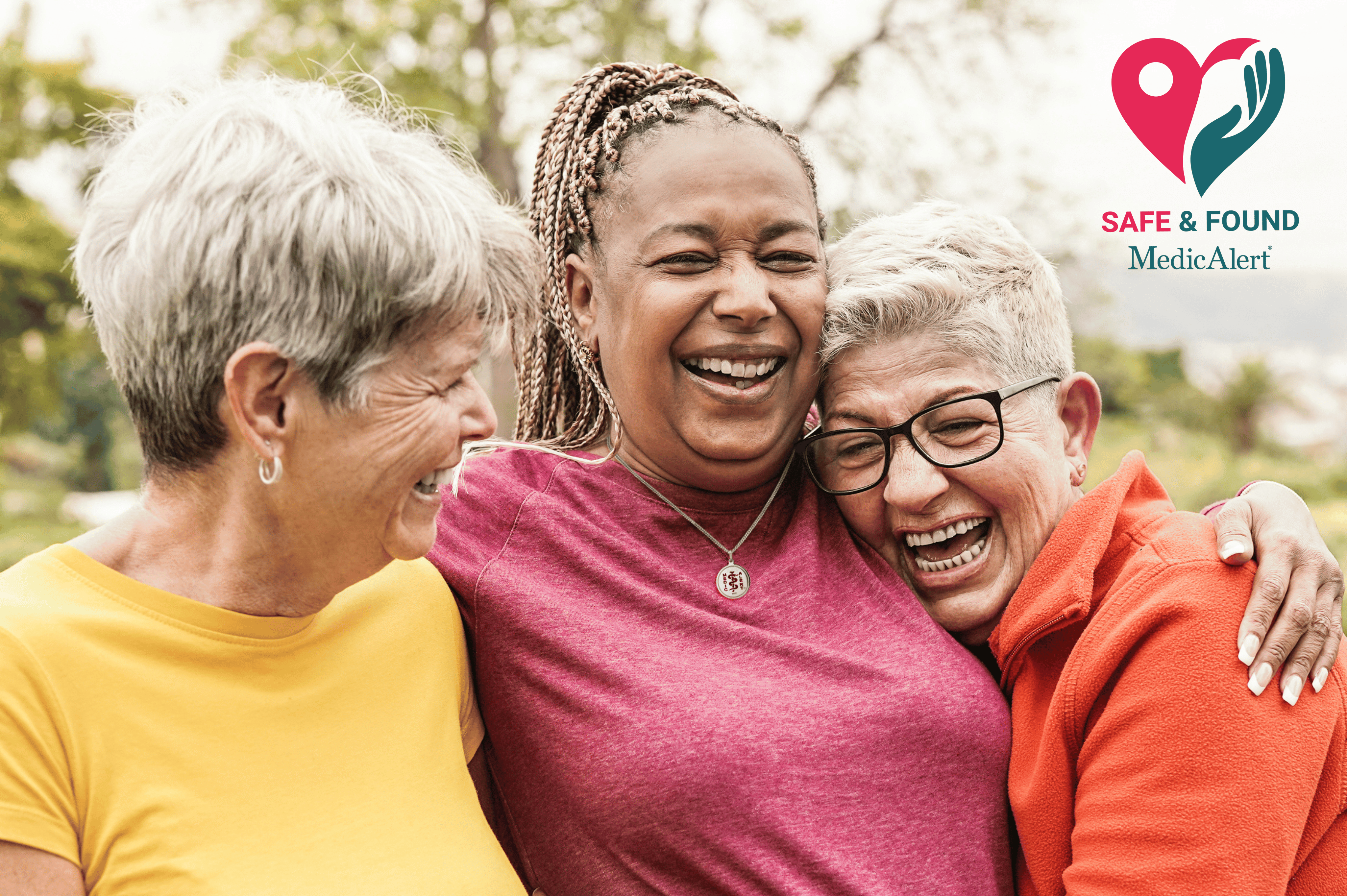Three women laughing with their arms around each other. A Safe & Found programme logo is in the top right-hand corner.