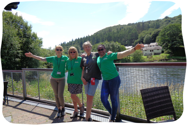 Volunteers pose in front of a river.